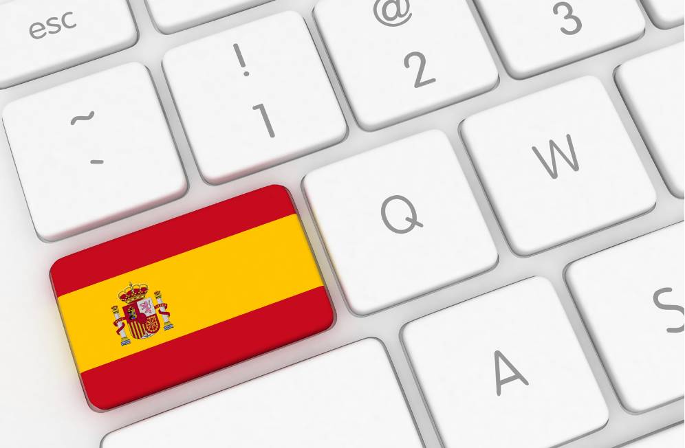 A white keyboard with a Spanish flag key.